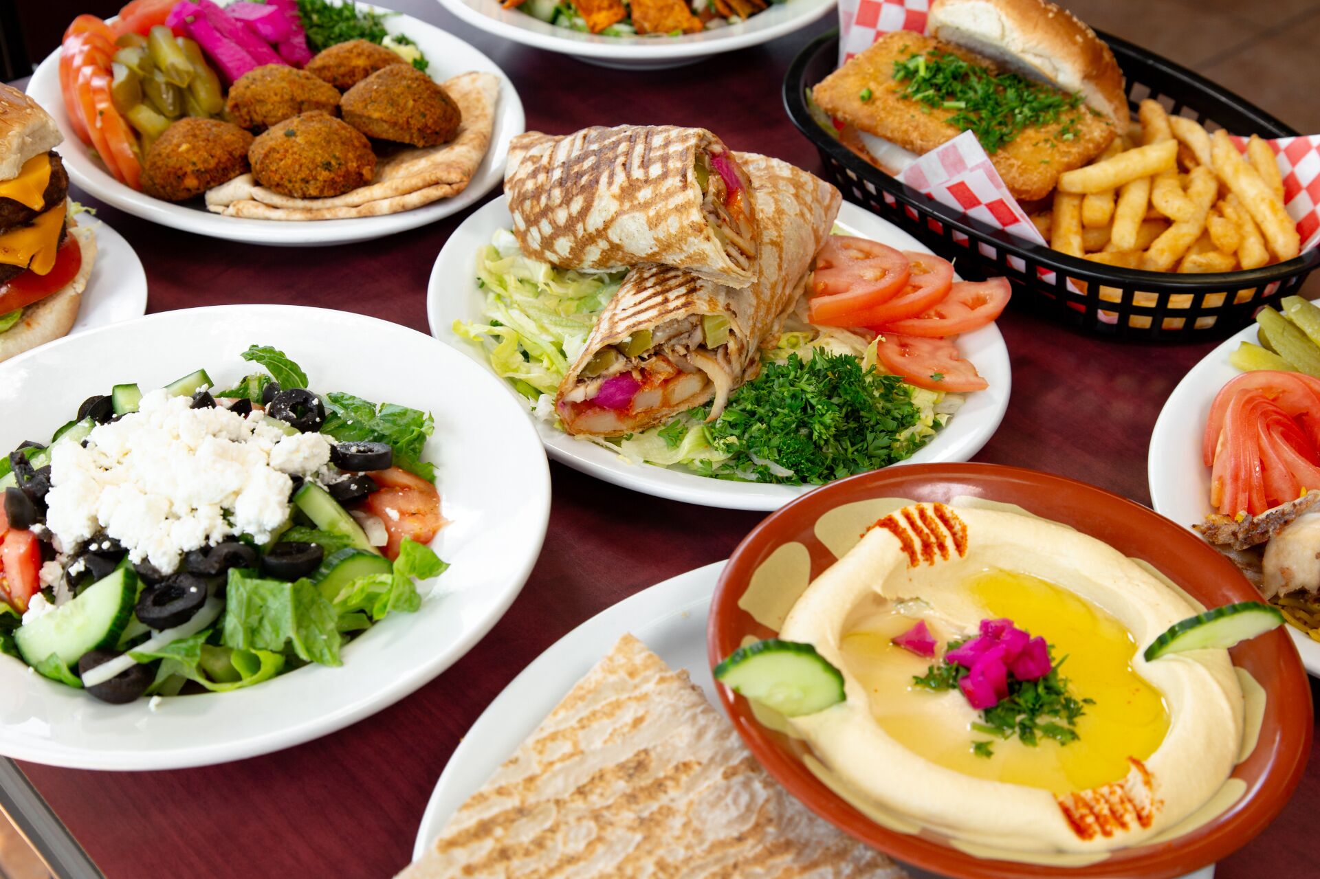 Middle Eastern mezze spread with hummus, kebabs and pomegranate